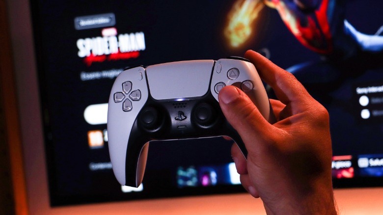 Person holding a DualSense controller