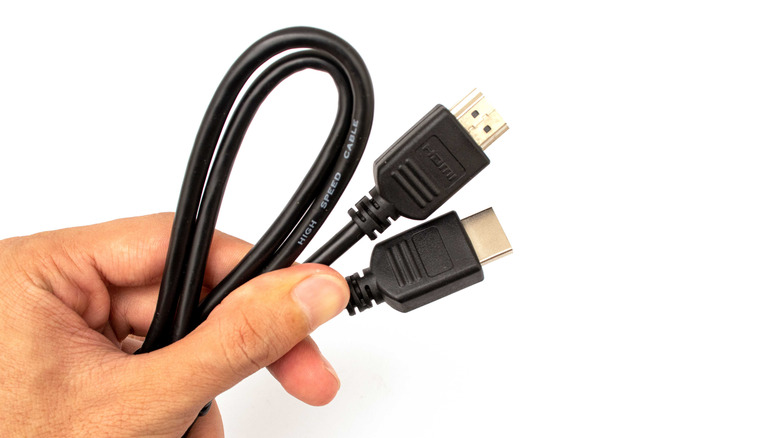 hand holding HDMI cable