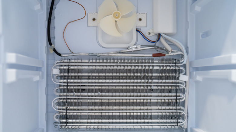 Closeup shot of the fan and cooling coil inside a refrigerator