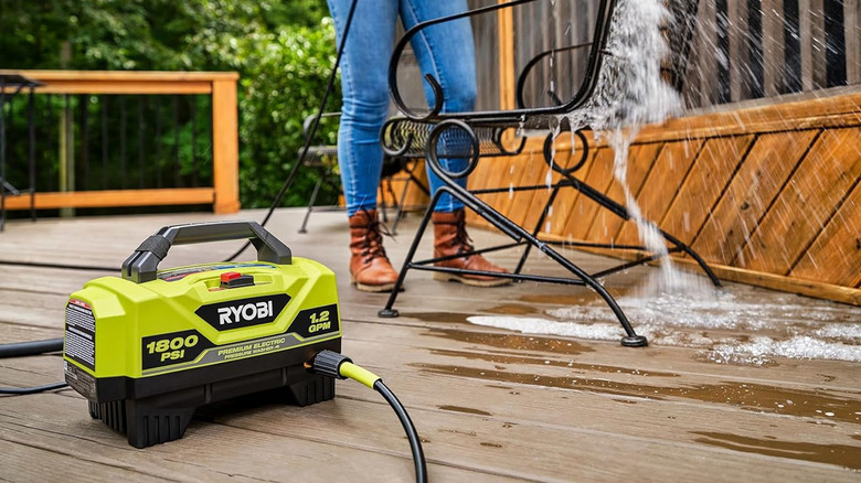 person using Ryobi pressure washer