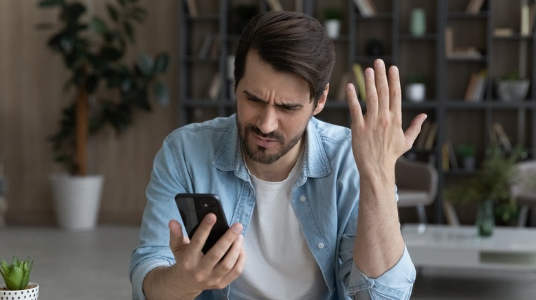 Man annoyed at phone