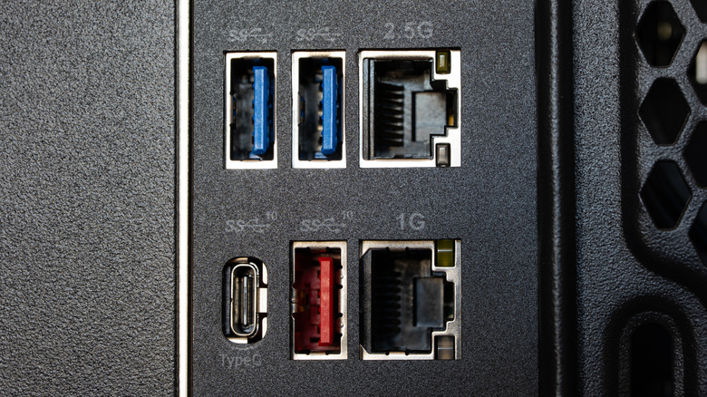 Macro shot of connections on the back of a desktop PC, including several USB ports