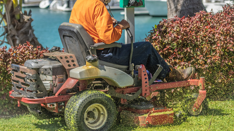 A man riding a zero-turn mower