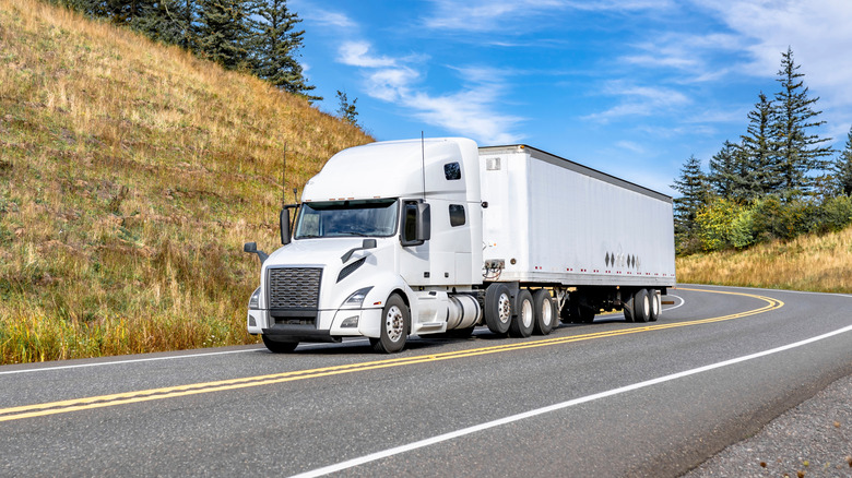 A commercial truck with green LED lights in the shape of eyes installed on the windshield