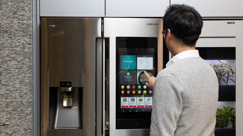man using smart fridge