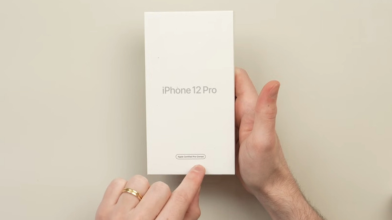 iPhone 12 Pro box in hand