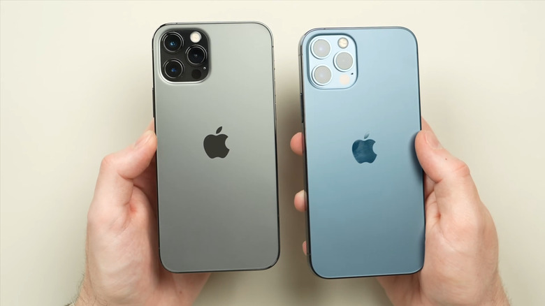 Hands holding iPhone 12 Pro Max models side by side