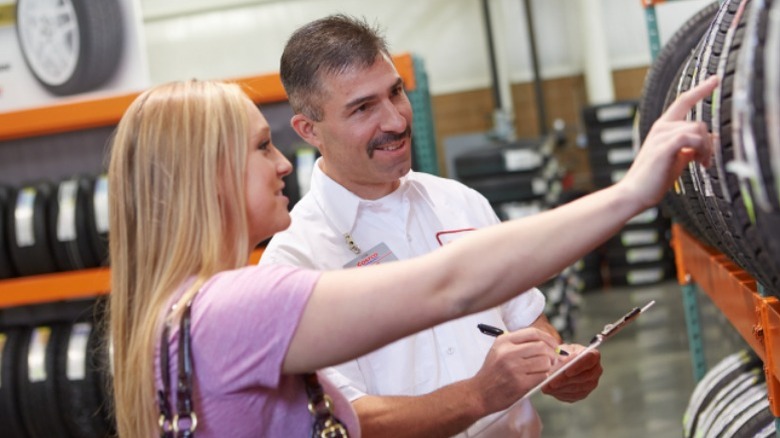 Customer picking out tires with salesperson