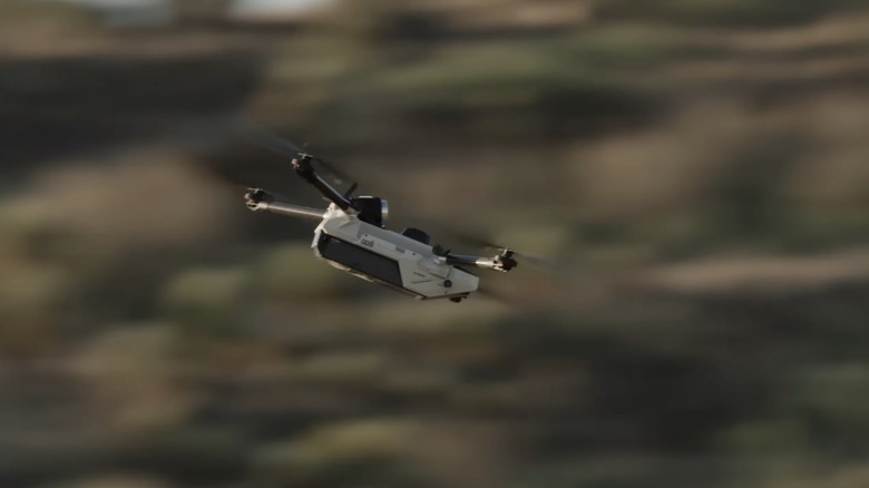 Anduril's Bolt drone flies over a hilly area