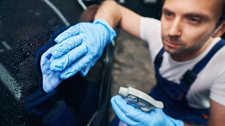 cleaning car in garage with degreaser