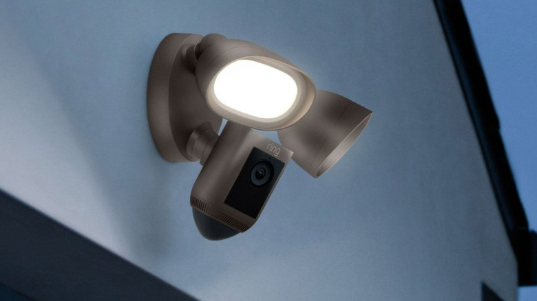A Ring floodlight security camera on a wall