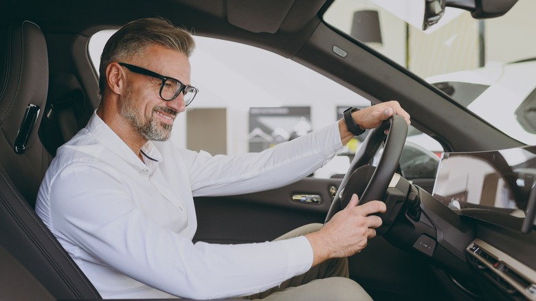 Adult man driving an electric vehicle