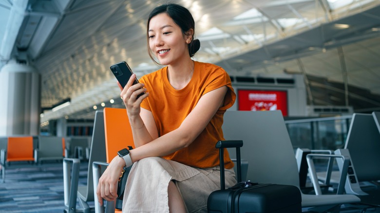 Woman waiting at airport terminal