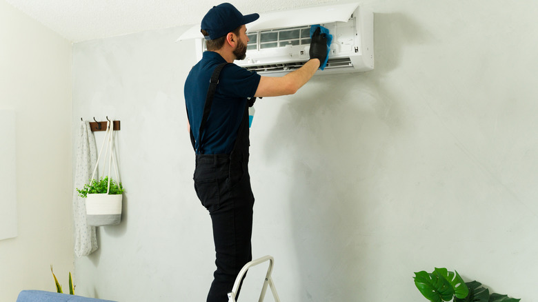 Man installing mini split indoors