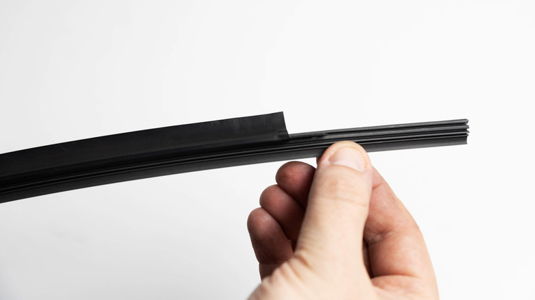 Person installing wiper blade refills