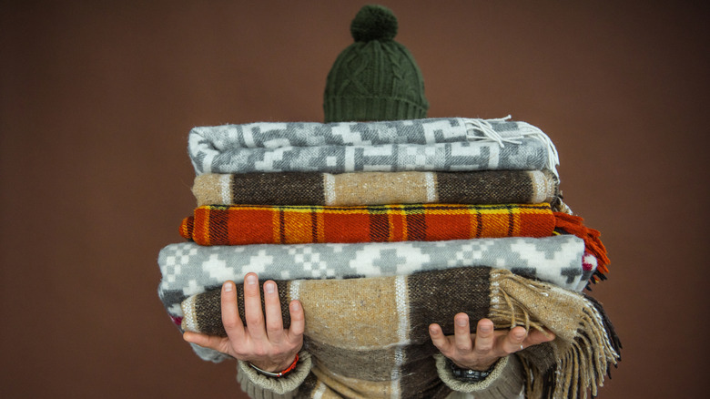 Person holding warm blankets