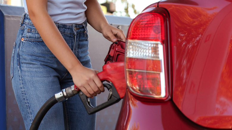 woman topping up gas car