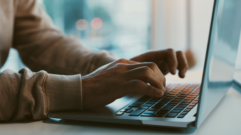 Person typing on laptop