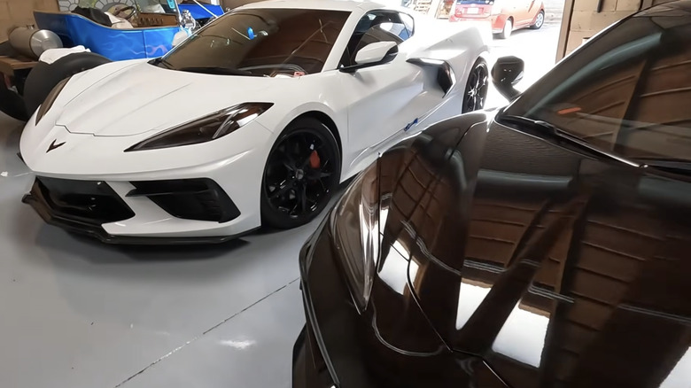 A couple of Corvette C8s parked in a garage