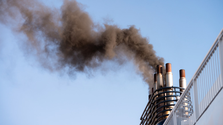 A plume of smoke coming from a ship's funnel