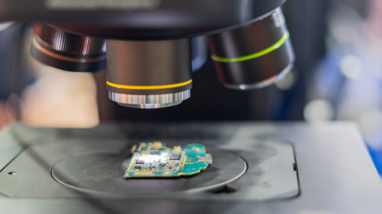 A microscope inspects a circuit board