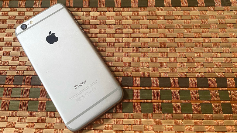 An iPhone 6 laying on a bamboo sheet