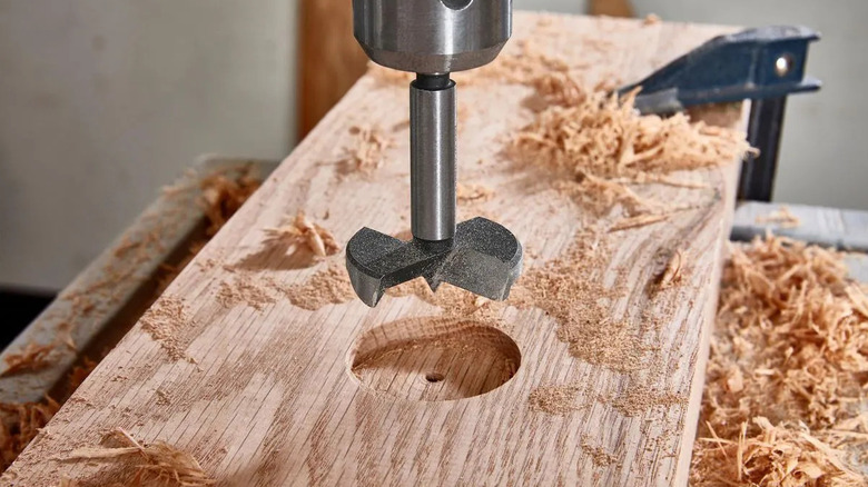 Warrior forstner drill bit attached to a drill