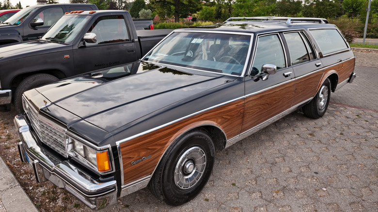 A Chevrolet Station Wagon with wood trims in a parking lot.