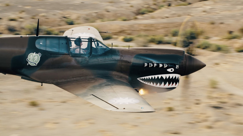 P-40 Warhawk firing its guns side view