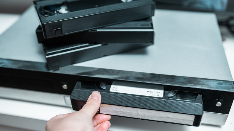 VHS tape being put into a player.