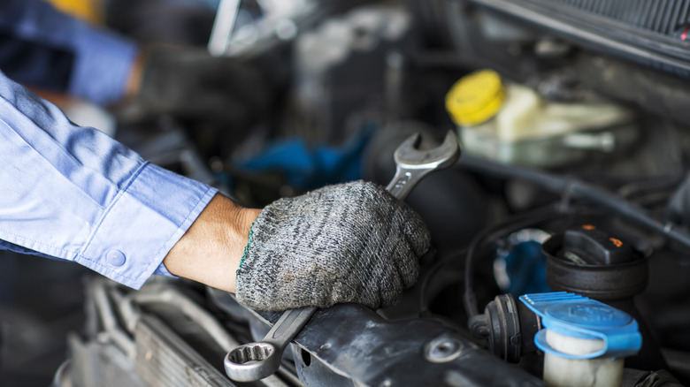 mechanic working under the hood