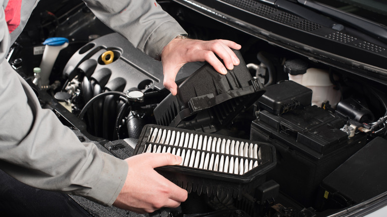 mechanic holding a filter