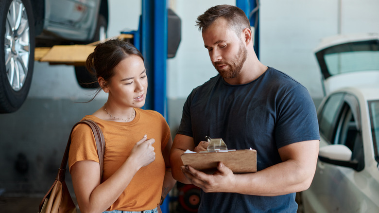 mechanic giving car owner a quote