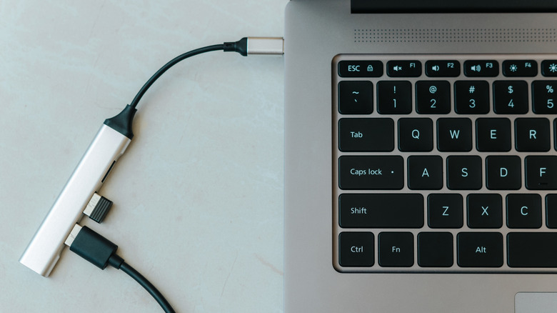 Top view of an opened Chromebook with a USB hub plugged in.