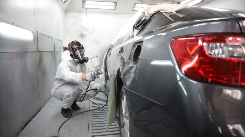 man spraying car