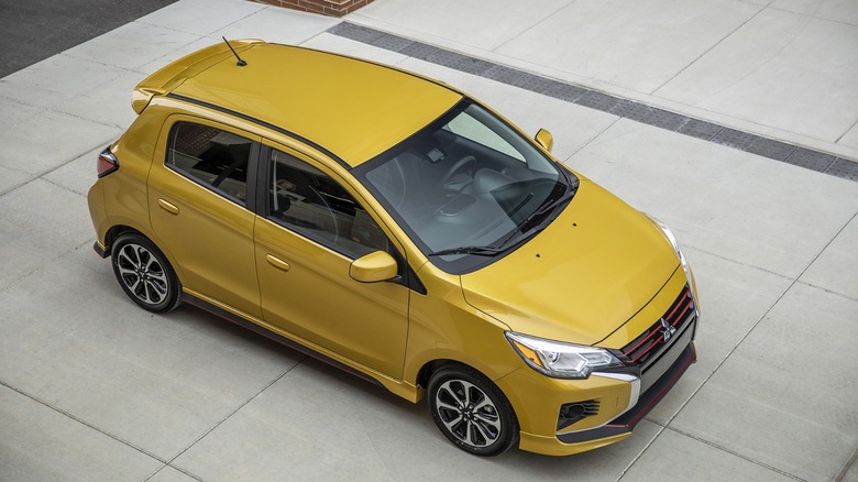 A clean top-down view of a 2024 Mitsubishi Mirage hatchback in sand yellow.