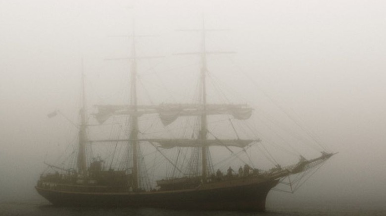 Ghostly sailing ship in fog