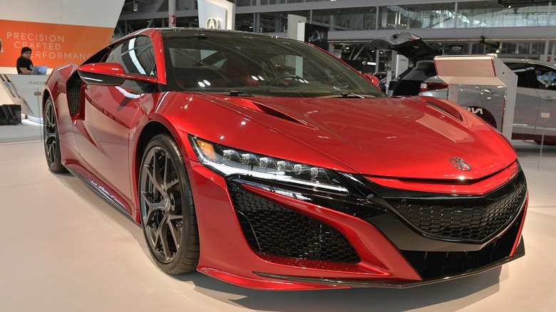 An Acura NSX sitting under an Acura studio lighting.