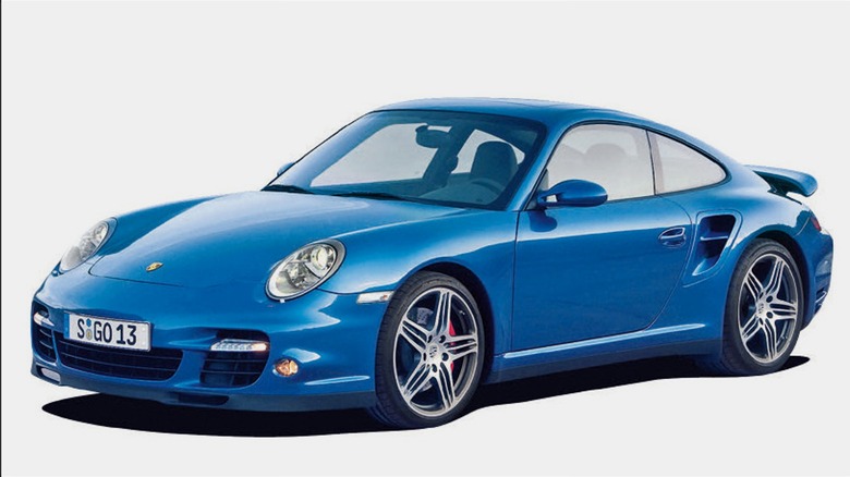 A blue Porsche 911 Turbo (997) coupe showing off its iconic curves on a plain background.