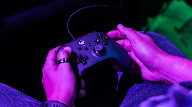 person holding black xbox one controller