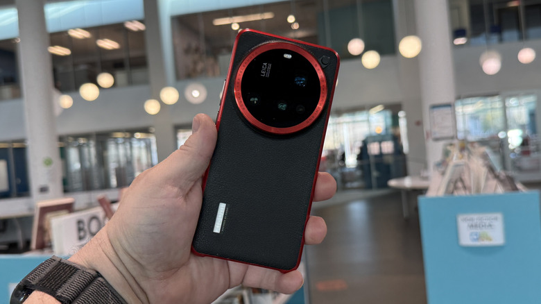 Hand holding the Xiaomi 15 Ultra with case.