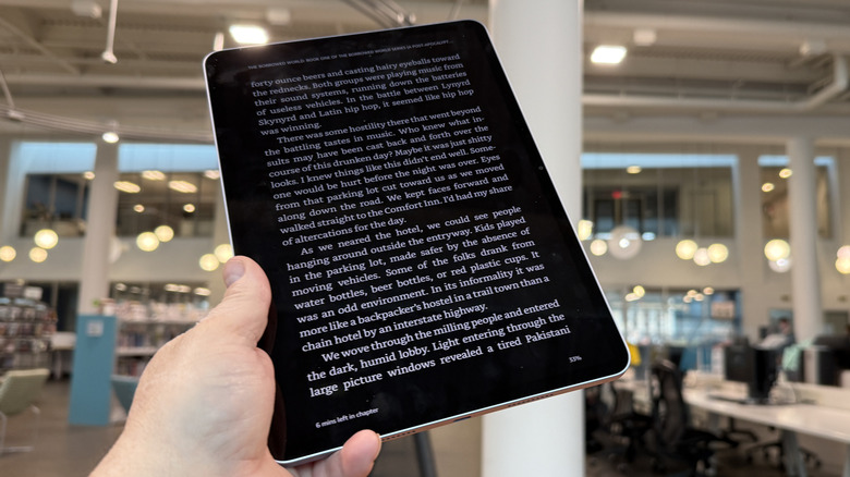 Xiaomi Pad 7 held aloft by a hand.