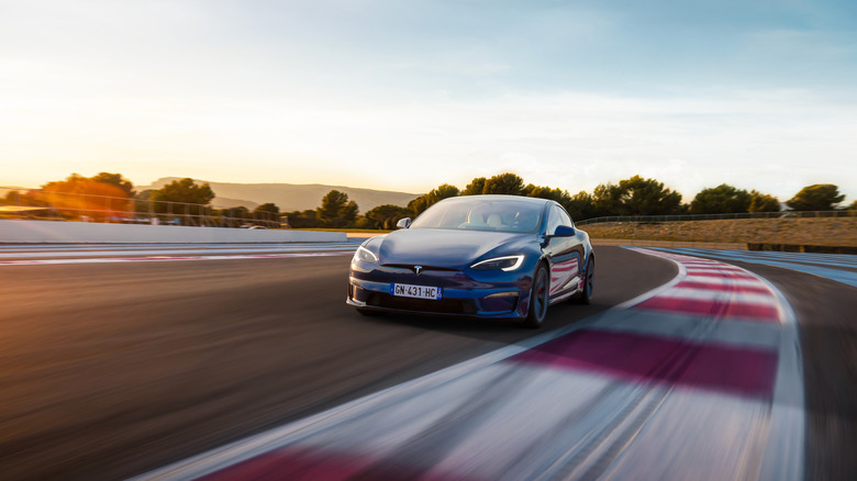 Tesla Model S driving around racing circuit, front-view