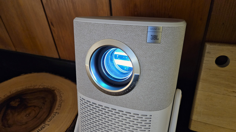 The Yaber T2 Plus Outdoor Projector while on showing the light coming out of the lens.