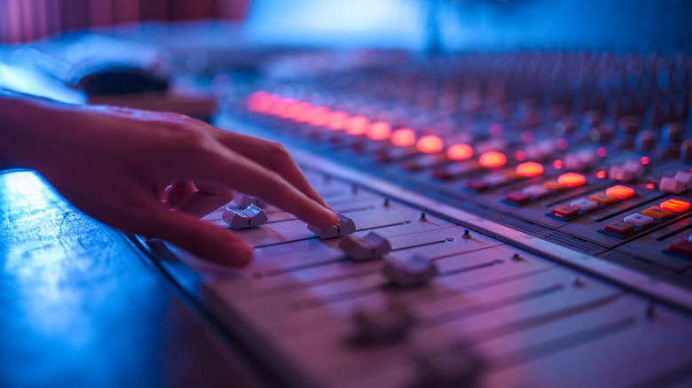 Man operating digital mixer