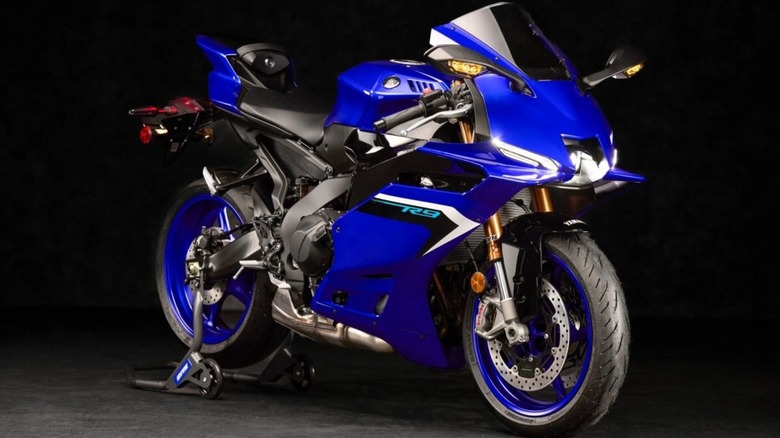 A side and front view of a blue Yamaha R9 against a black background