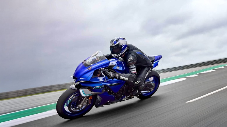 A blue 2025 Yamaha YZF-R1 cornering on a race track