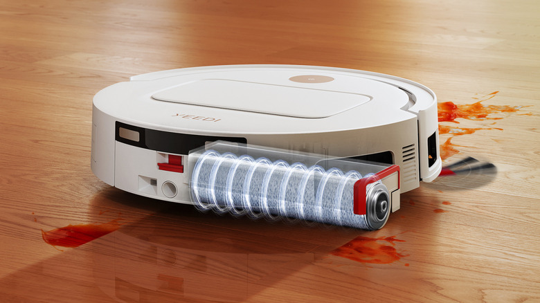 YEEDI M14 PLUS mopping up milk on floor with SlashGear Innovation Award badge