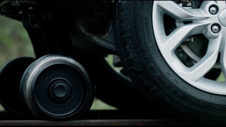A close up shot of the Land Rover Discovery Sport modified rail guides to pull a train in Switzerland.