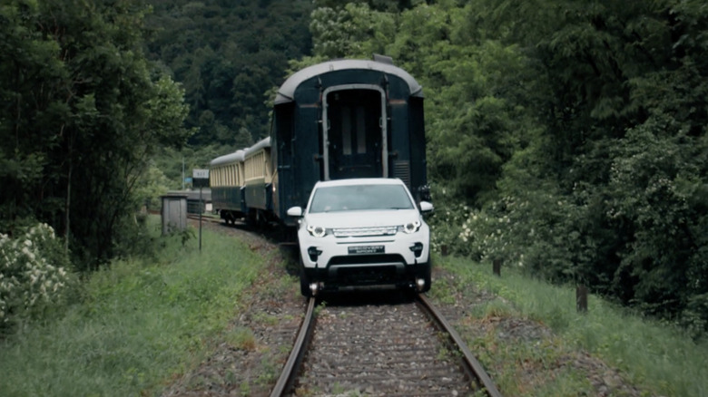 A front end shot of the Land Rover Discovery Sport pulling a train in Switzerland.